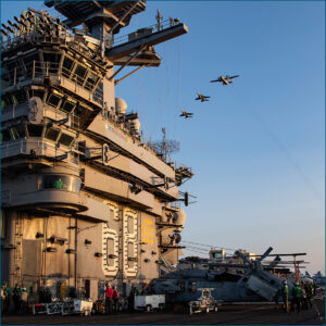 Aircraft carrier and jets flyover
